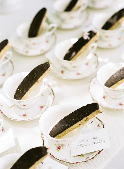 TAKE A DIP: Liz has a sweet tooth, so the coffee and tea bar featured treats like chocolate-dipped biscotti presented on English rose-patterned teacups, which also served as favors. Guests’ table numbers were written in calligraphy on cards tucked under the cups.