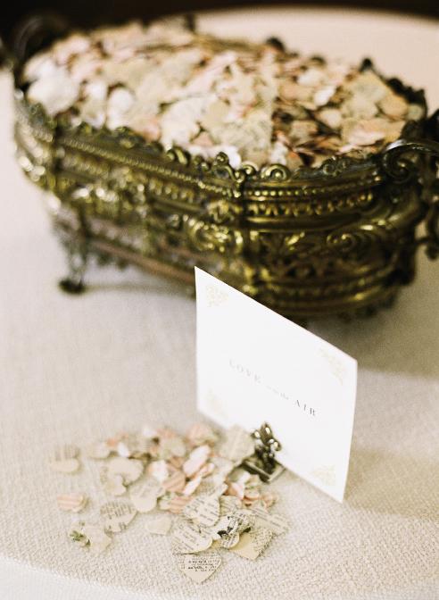 WORDS OF WISDOM: Flower petals and heart-shaped confetti punched from pages of books rained down on the couple as they left the reception.