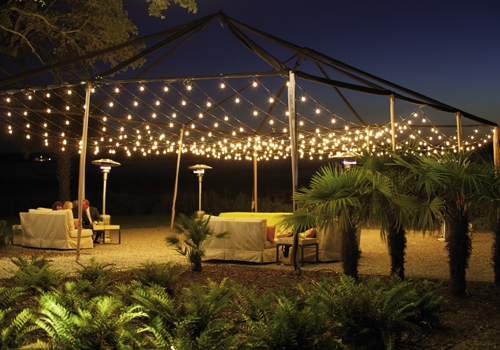 LATE NIGHT TALK SHOW: Palmetto trees, torches, and string lights formed an intimate outdoor setting for conversation.