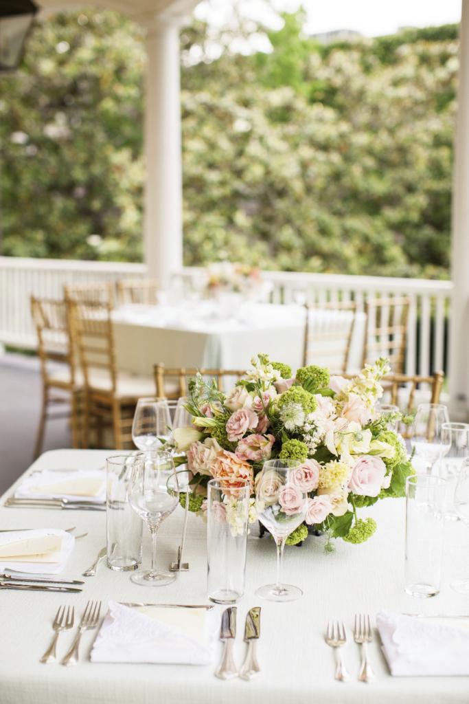 CENTER OF ATTENTION: Combinations of pastel-colored double tulips, dusty  miller, eucharis lilies, peonies, scented geranium, and spray roses topped each table.