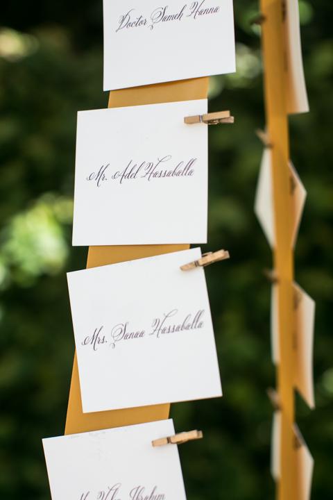 PICK ONE: Melissa Barton of A Charleston Bride affixed escort cards to golden strips of fabric with tiny gilded clothespins.
