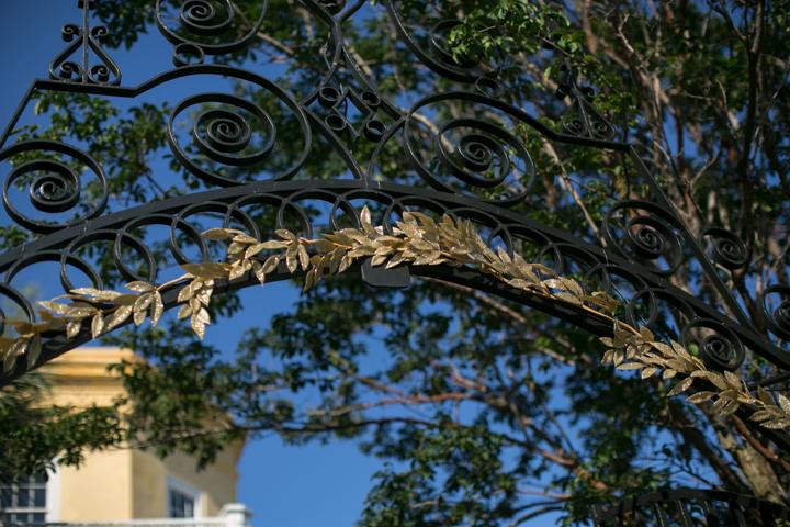 LEAVES OF GRASS: Golden fronds woven into the house’s wrought iron gates beckoned guests to enter.