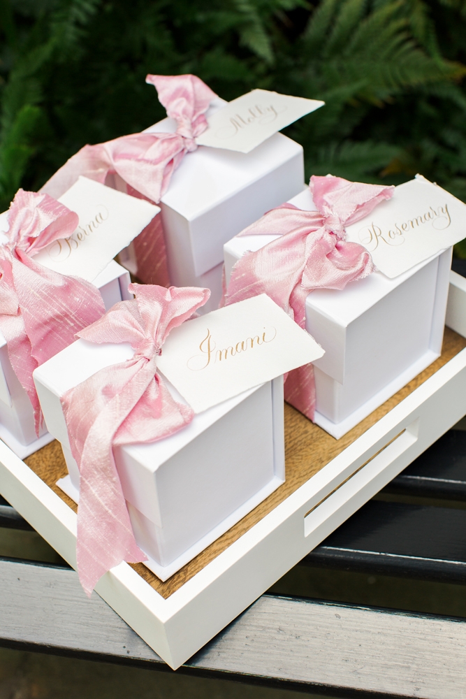 Sweetly wrapped boxes from A Signature Welcome held luxe gold earrings; calligraphed nametags lent a bespoke touch to favors. &lt;i&gt;Photograph by Gayle Brooker&lt;/i&gt;