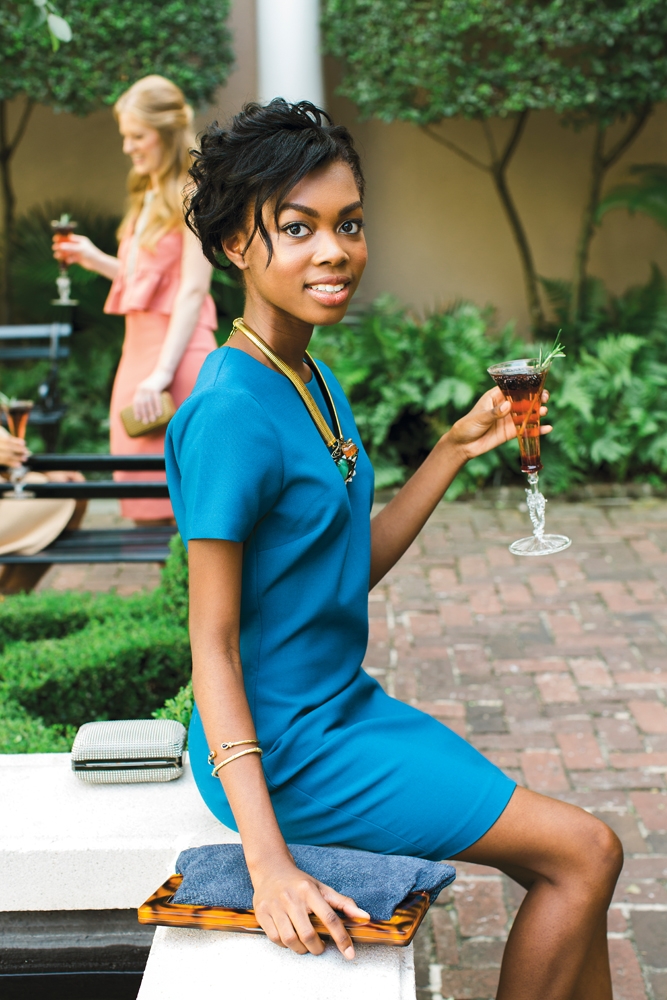 WHAT SHE WORE: Imani in Likely’s knit dress in “cerulen” from Copper Penny; Iradj Moini necklace from RTW; gold bangles from Croghan’s Jewel Box; “Harris” suede clutch in demin from J.McLaughlin. Whiting &amp; David’s “Dimple Mesh Minaudiere” clutch in pewter from Shoes on King. &lt;i&gt;Photograph by Gayle Brooker&lt;/i&gt;