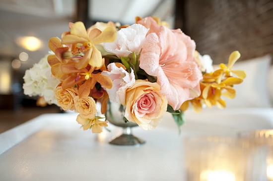 PRETTY IN PEACH: Amaryllis, lisianthus, and parrot tulips added pops of peach and orange to the reception décor.
