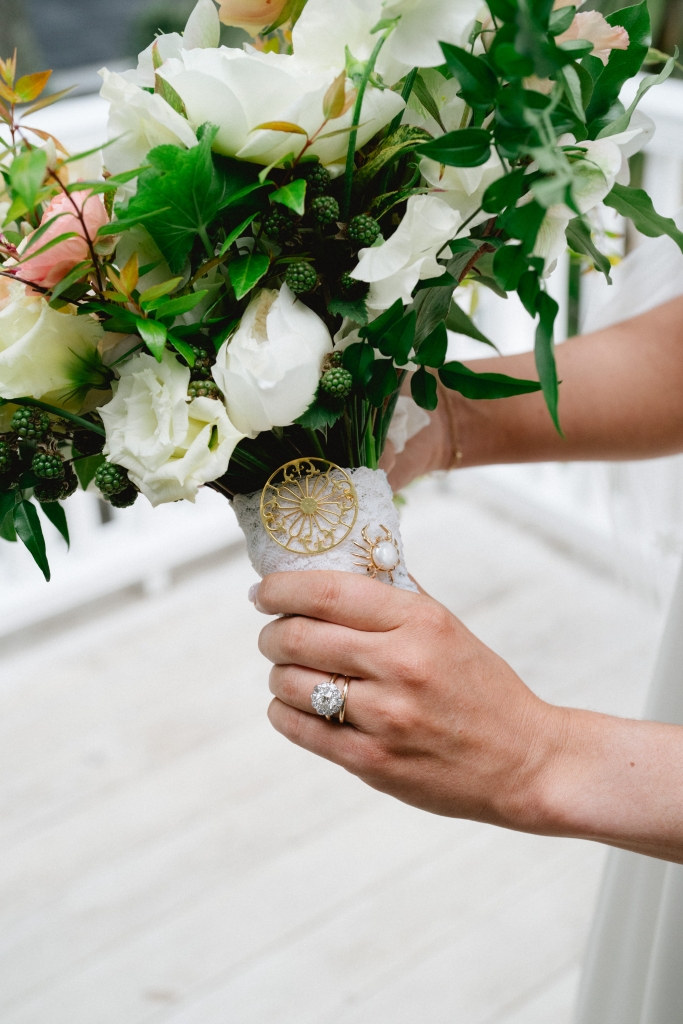 Libby’s estate Georgian cluster ring from Croghan’s Jewel Box dazzled next to her late grandmothers’ brooches, each pinned to lace from her mother’s wedding dress that was wrapped around her bouquet.