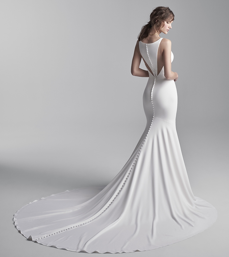 CLEAN DESIGN - “Anthony” halter-back mermaid dress by Sottero and Midgley Why We Love It “Simple, clean dresses are definitely having a moment. What we love about this dress is the architectural seaming and lines.”   –Jessica Kiss, Verità.  A Bridal Boutique