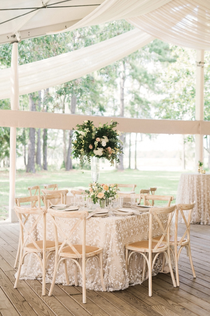 The table settings featured beautiful floral embroidered tablecloths from Nüage Designs, plates that mimicked the bridesmaids’ green gowns, letterpress menus, and tall centerpiece vases of flowers. The couple dined privately under the oak tree, which gave them a few moments of privacy to bask in wedded bliss.