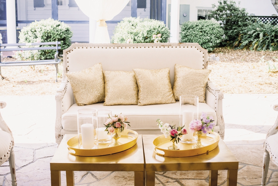 Gold sequin throw pillows gave linen-covered settees a glittering accent that answered the bride’s dream of rustic-meets-glitz styling.