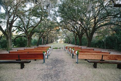 HALLOWED GROUND: Rows of pews transformed the oak allée at the Legare Waring House into a cathedral-like setting for the ceremony.