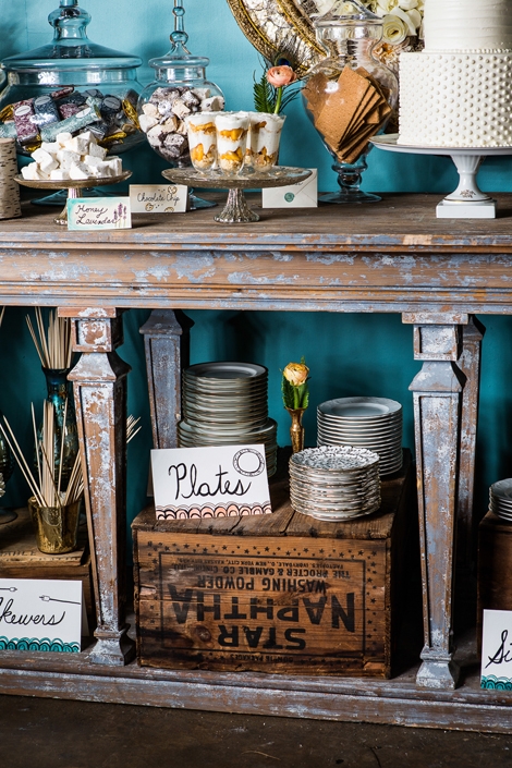 DOUBLE DECKER: Make full use of space and stock lower shelves with more goodies or necessities, like these serving plates. Call attention to tucked away items with signage to gently guide guests.
