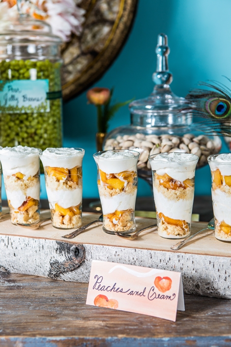 PARFAIT PALETTE: Desserts like these peach parfaits were chosen for the way the color complements the turquoise backdrop and picks up the pinks in the flowers. Artist Kristin Solecki&#039;s sweet and playful sign sports a few of the plump fruits.
