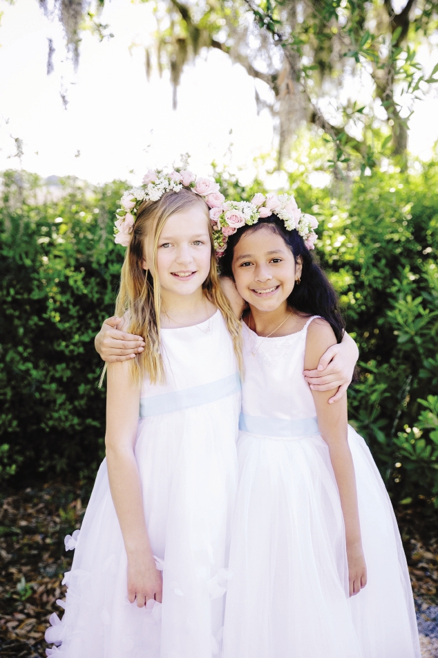 GRINNING GALS: Floral crowns from Branch Design Studio added color to the flower girls’ angelic ensembles