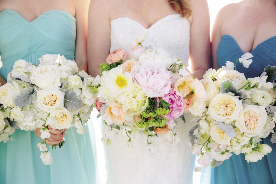 STANDOUT: Pastel flowers popped against the bride’s Mori Lee gown from Jean’s Bridal, while muted bouquets complemented her attendants’ Donna Morgan frocks from Bella Bridesmaids.