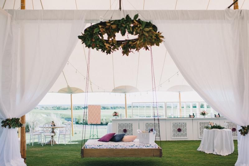 Wedding and floral design by A Charleston Bride. Bed swing from Ooh! Events. Custom fabrics designed by Blue Glass Design. Photograph by Sean Money &amp; Elizabeth Fay at the Ocean Course at Kiawah Island.