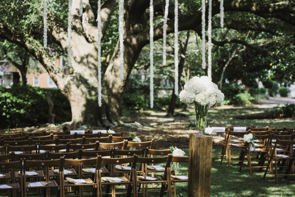 SUMMER WHITES: Julie wanted to enhance Lowndes Grove’s natural beauty with only white flowers, so A Charleston Bride and florist Tiger Lily Weddings decorated the ceremony with simple, lush hydrangea arrangements and hung flower streamers from the trees to form the altar space.