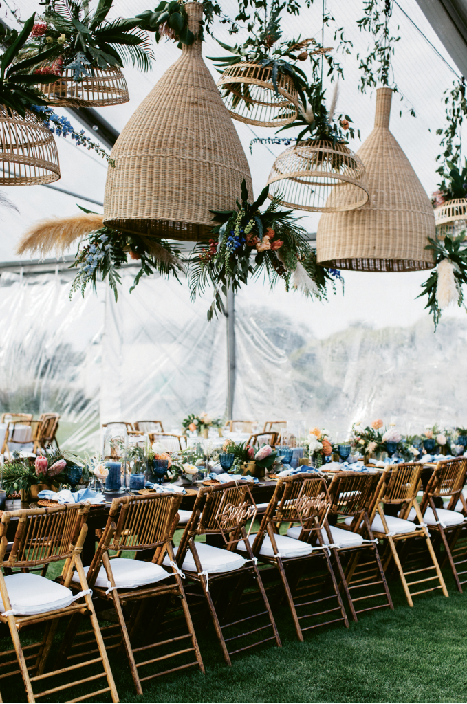 The extra large rattan shades over the head table answered the couple’s request for a laid-back coastal vibe.