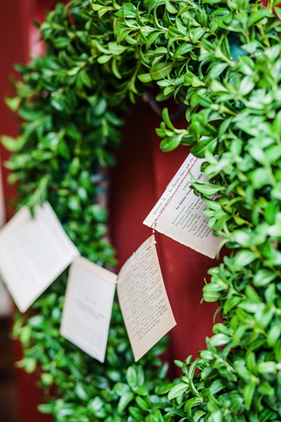 BANNER TIME: An evergreen wreath, strung with a garland sewn with vintage book flags, welcomed guests.