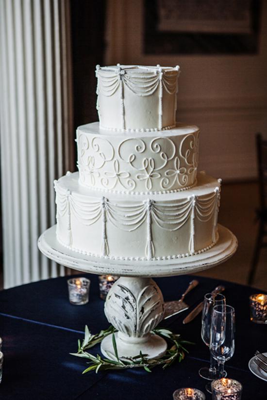 PIPED PERFECTION: Jim Smeal of Wedding Cakes by Jim Smeal created a white three-tiered wedding cake.