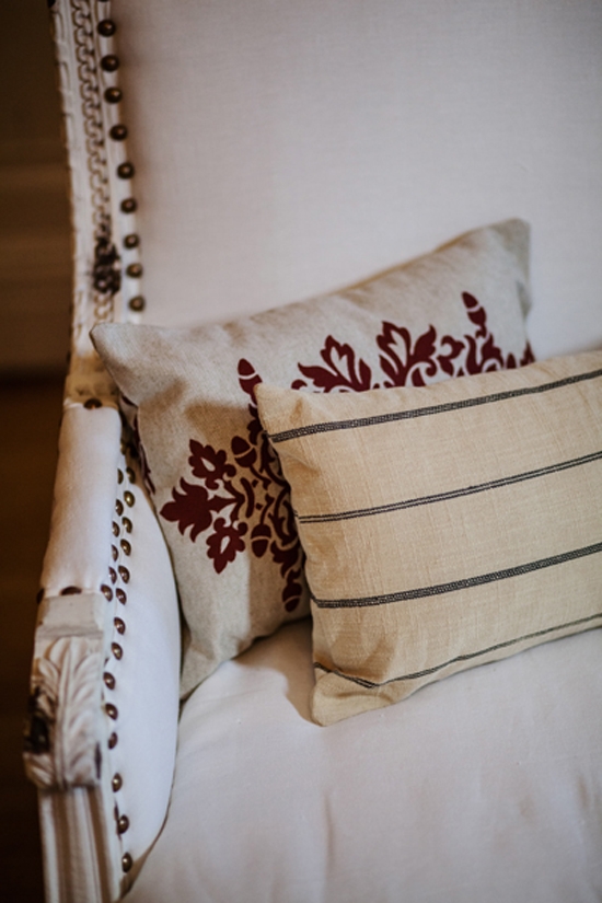 FRENCH COUNTRY: To add a hint of vintage, textured pillows were tossed onto pristine white couches.
