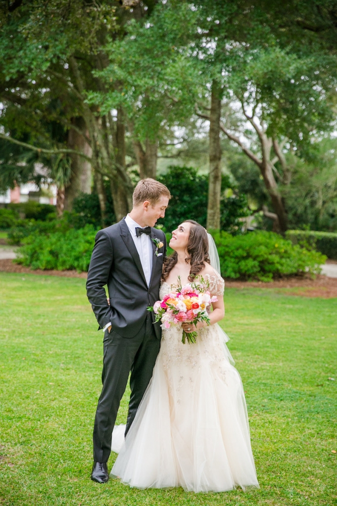 Bride&#039;s gown by Monique Lhuillier, available in Charleston through Maddison Row. Hair and makeup by Paper Dolls. Groom&#039;s attire by Hugo Boss. Florals by Branch Design Studio. Image by Dana Cubbage Weddings at Lowndes Grove Plantation.