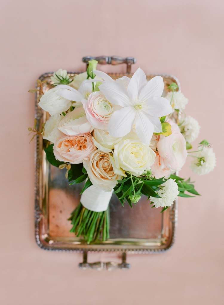 Meggie wanted the day’s florals to evoke romance. Blossoms Events delivered in spades, using a springy mix of lisianthus, garden roses, clematis, ranunculus, and scabiosa for the bridal bouquet. &lt;i&gt;Image by Lucy Cuneo Photography&lt;/i&gt;