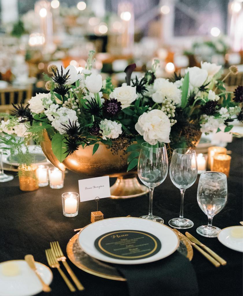 Given that the bride’s family loves black and white everything, given the groom’s a fan of the Saints, and given that New Year’s Eve pretty much equals black, white and gold, Alexa went with that formal color scheme to dress the couple’s Big Day.