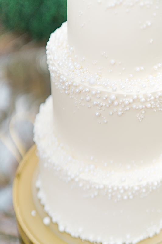 Pastry chefs will often repeat a motif from a bride’s gown or other element for a cohesive look, like this subtle design by Taryn DeYarman of Flowerchild.