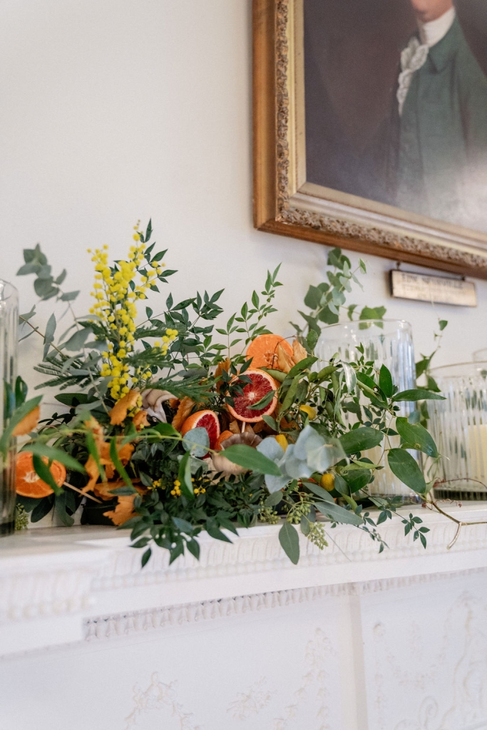 Fresh citrus, yellow mimosa, eucalyptus, and Italian ruscus.