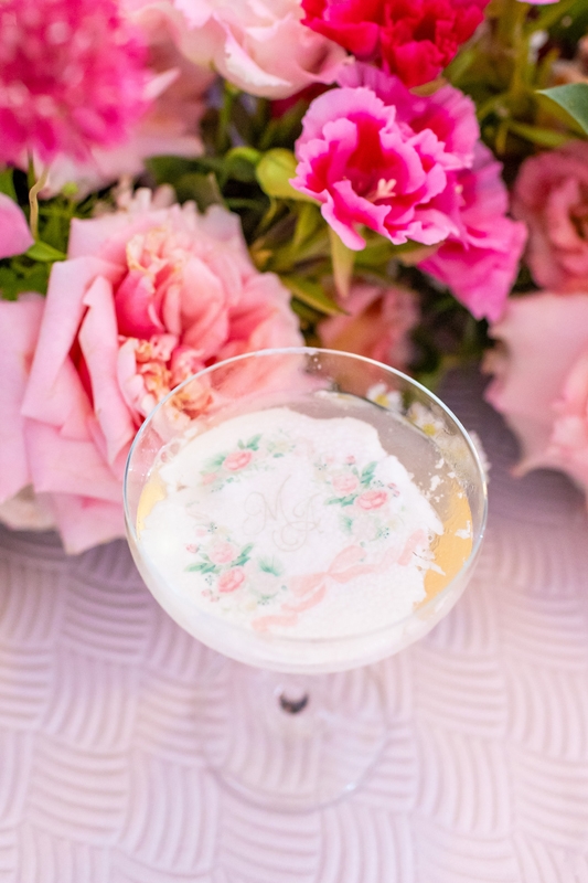 The couple’s beribboned crest appeared throughout, including on napkins, carved into an ice sculpture, even floating atop glasses of Champagne.