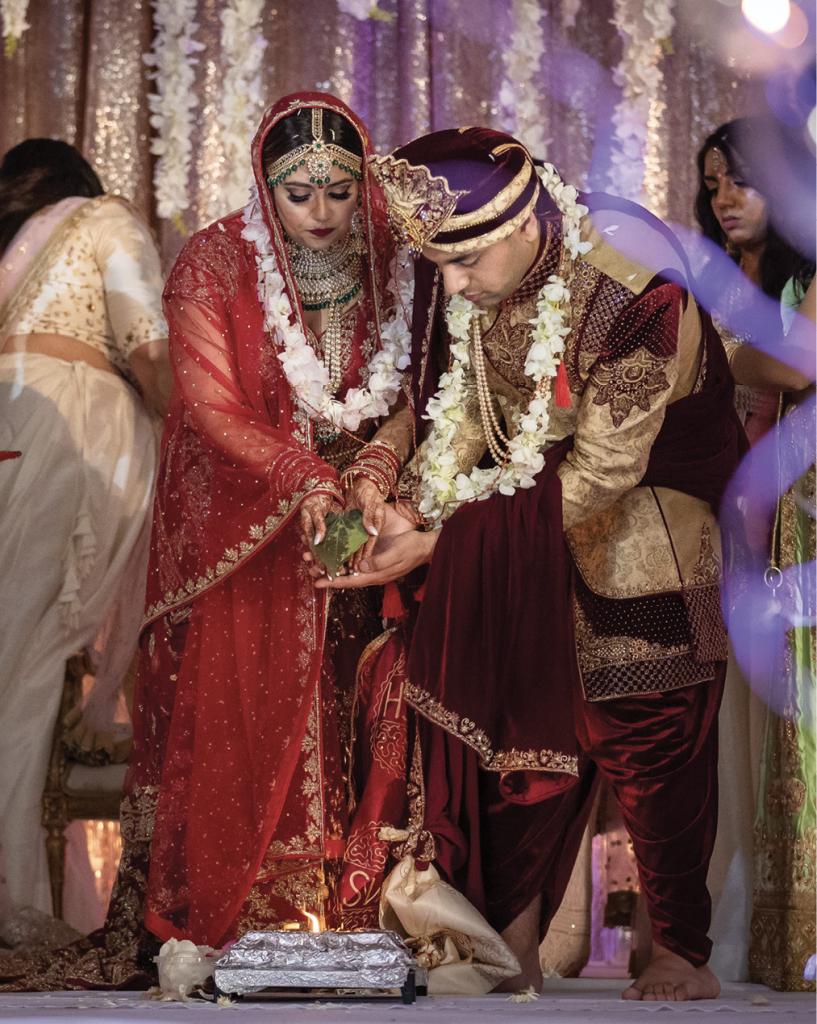 Adhering to tradition, the groom wore a crimson sherwani frock.