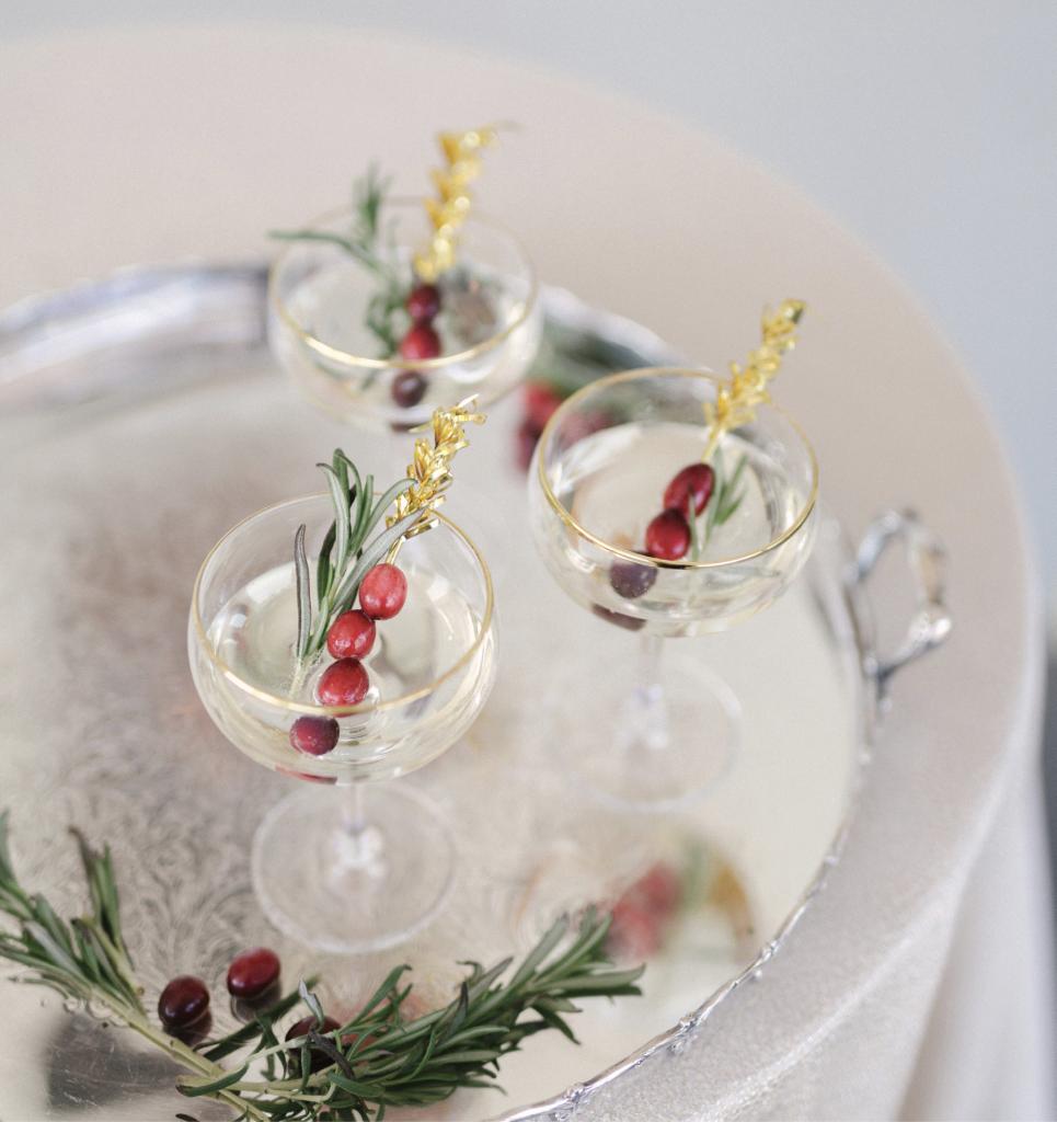 For Christmastime  nuptials, opt for natural seasonal touches, like sprigs of rosemary and cranberries for champagne garnishes.