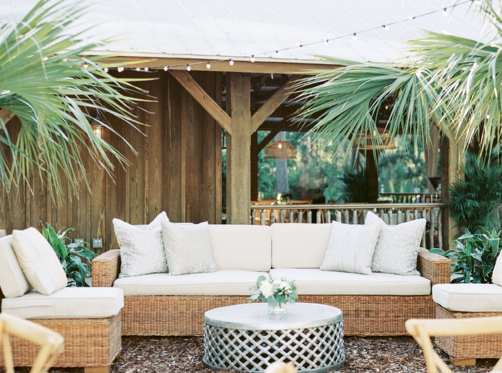 Shimmering elements—pillows, tables, linens—played off the gray and white tabby of the site and its tin-roof shelter.