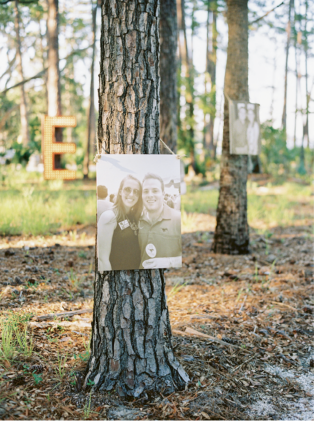Along the walk to the landing, oversized photos of the couple hung on the trunks of pines.