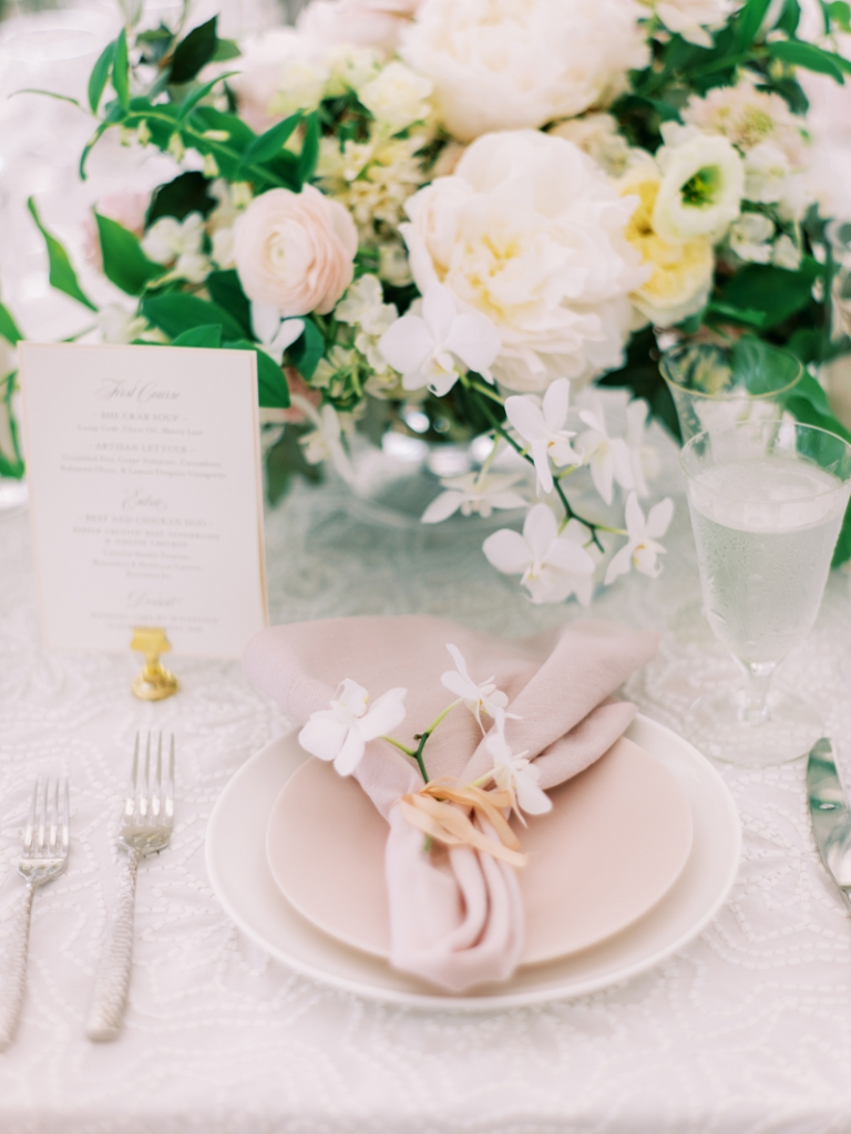 The wedding’s palette of soft pinks and white carried through to place settings.