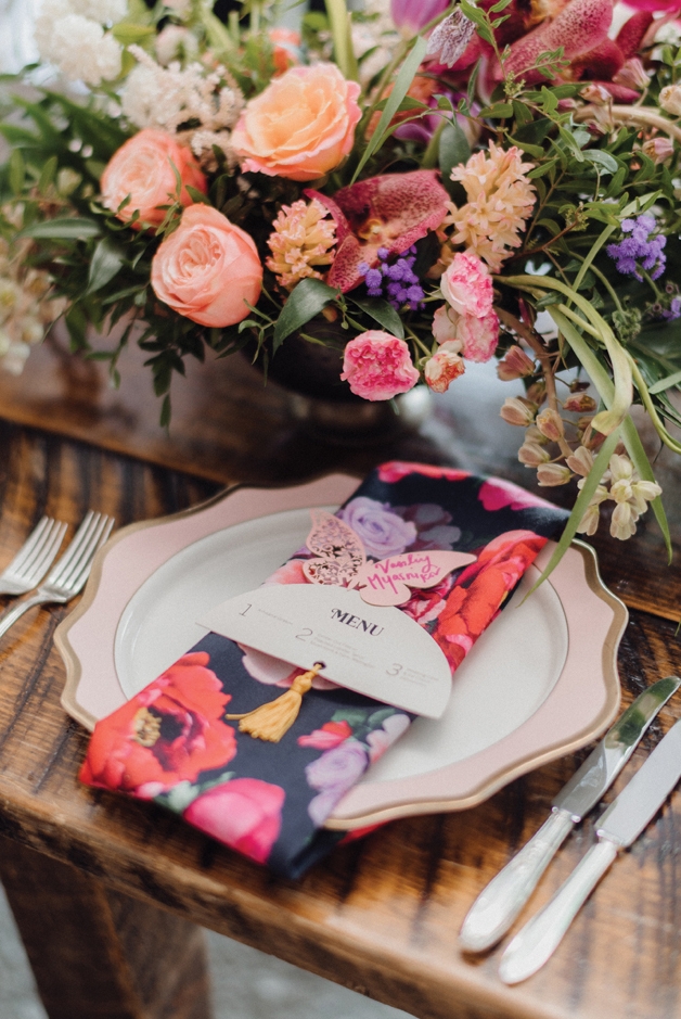 Color was in abundance on the tablescapes. The name cards were a nod to the couple’s engagement on a beach filled with butterflies.