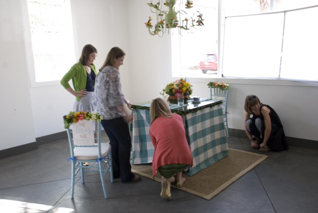 Seriously business here: aligning the Celadon rug so the table’s centered from photographer Frank Edward’s perspective. I’m looking at him and laughing. It’s always so weird how lining things up in the camera might not match reality.