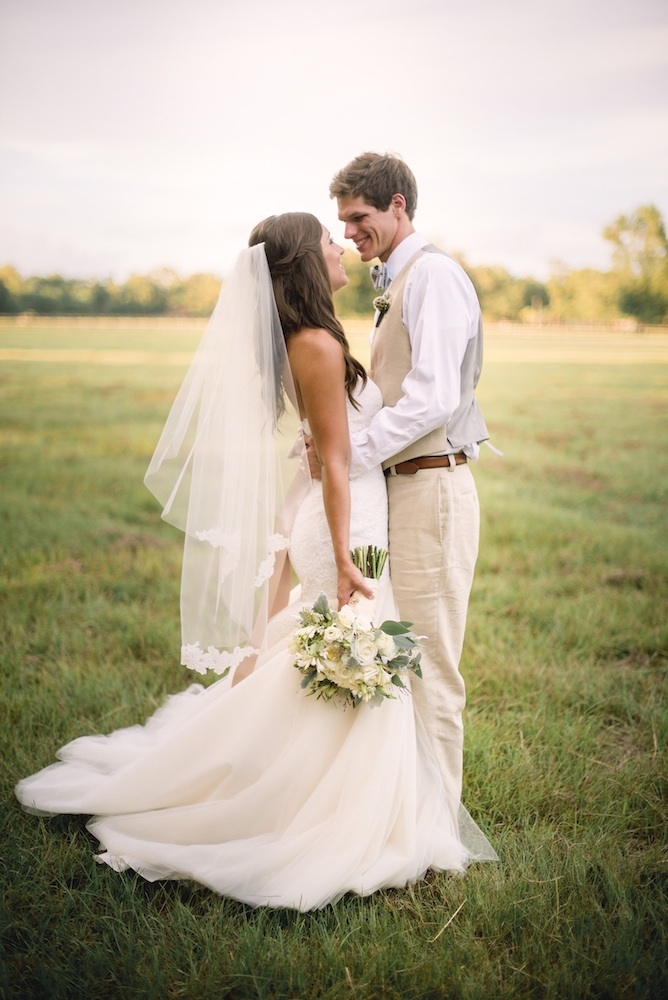 Bride&#039;s gown by Legends by Romona Keveza (available locally through Maddison Row). Groom&#039;s suit by Calvin Klein. Florals by Out of the Garden. Image by Timwill Photography.