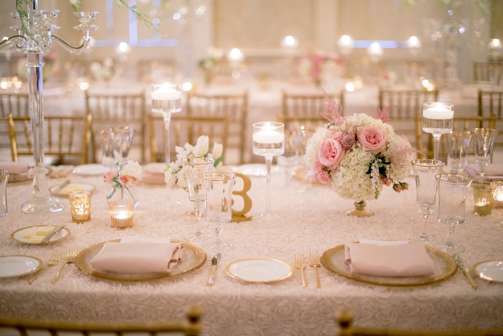 Wedding design by Sage Innovations. Table numbers by Z Create Designs. Florals by Branch Design Studio. Chairs from Snyder Events. Flatware, china, and chargers from EventWorks. Linens from I Do Linens. Image by Timwill Photography at McCrady&#039;s Restaurant.
