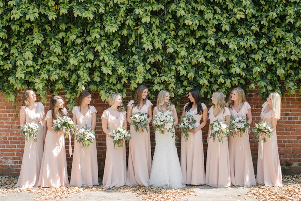 Bride&#039;s gown by Monique Lhuillier (available locally at Maddison Row). Bridesmaid dresses by Jenny Yoo (available locally at Bella Bridesmaids and Fabulous Frocks). Bouquets by Sara York Grimshaw Designs. Photograph by Sean Money + Elizabeth Fay.