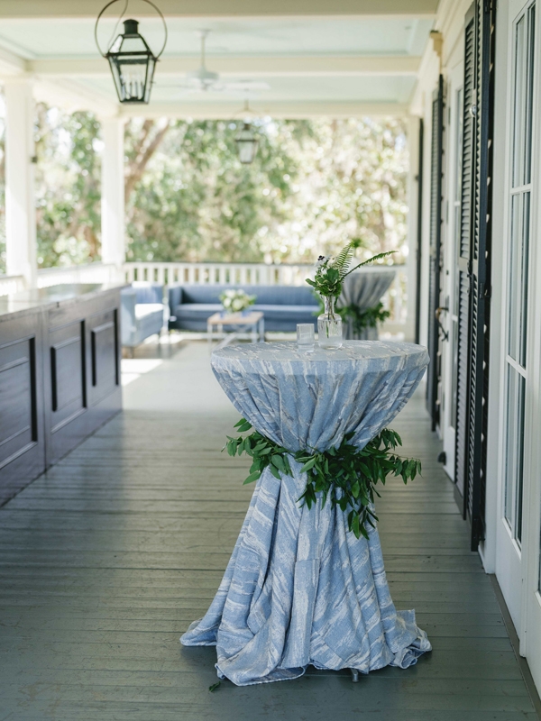 Blue-hued linens and abundant fresh greenery reflected the landscape.