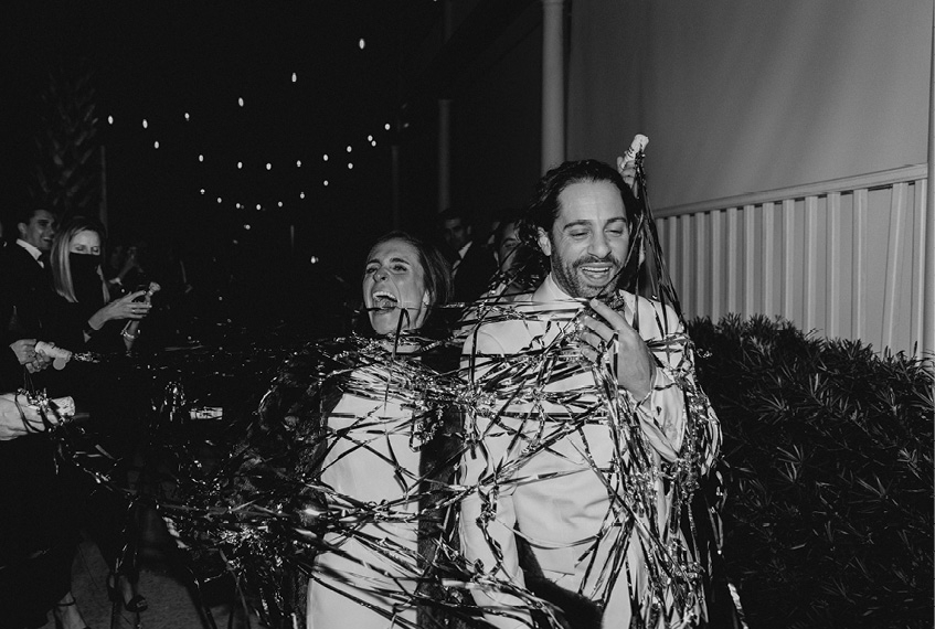 For their send-off, pop-out streamers enveloped the couple in a riot of ribbon and laughter.