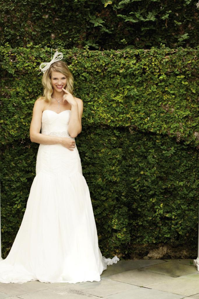 All Smiles: Martina Liana ruched bodice gown with drop waist and beaded sash from Gown Boutique of Charleston. Fascinator from KiraElizabethDesigns.com. Platinum diamond necklace from Joint Venture. 18K white gold diamond ring by Christopher Designs from Croghan’s Jewel Box.