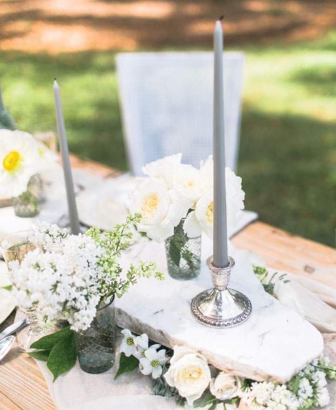 TIERS OF JOY: Try a stackable table runner (like Anne Dabney of Charleston Stems did here) to maximize space. She placed floral foam between marble slabs and then tucked blooms into the foam. The flat slab tops allow for candles, table numbers, bread baskets, and bouquets.