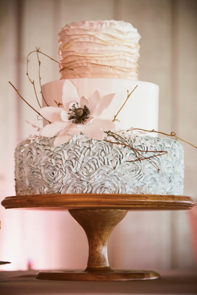The Wedding Cakes by Jim Smeal creation was a true collaboration. Catherine chose the ruffles while Christina suggested the magnolia-inspired accent floral. “It needed some kind of natural, rustic element to make it a little less formal and a lot more fun,” says Christina, “so we added the twigs and voilà!”  &lt;i&gt;Amelia + Dan Photography&lt;/i&gt;