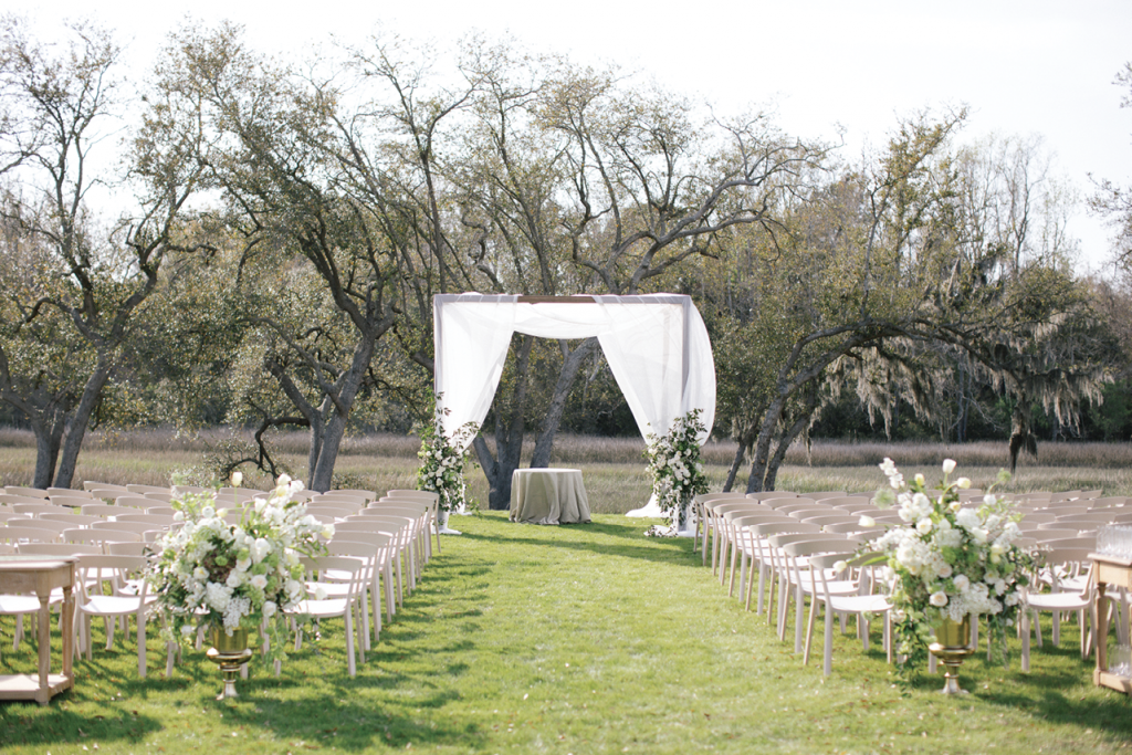 Under a simply draped arbor, the couple exchanged vows in an inter-faith ceremony conducted by both a rabbi and a priest.