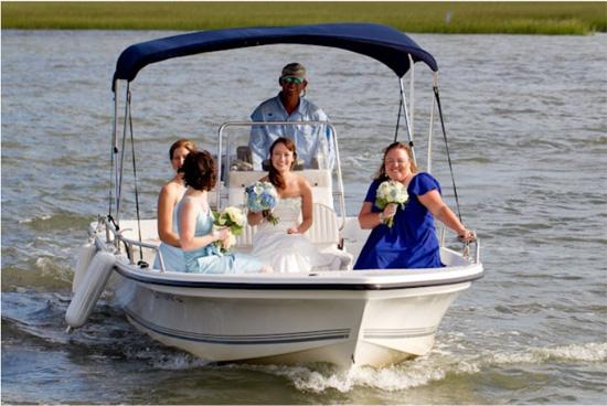 MIX N’ MATCH: Cindy and her bridesmaids, who wore monochromatic blue dresses from David’s Bridal and Ann Taylor, arrived to the ceremony via boat. The captain’s boat shirt even color coordinated with the ladies’ attire.