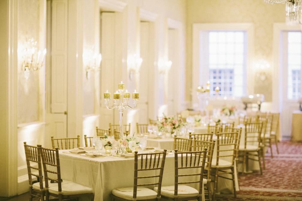 To set off the sparkling accents, incorporate neutrals—like pale linens, gold chiavari chairs, and clear crystal candelabras.