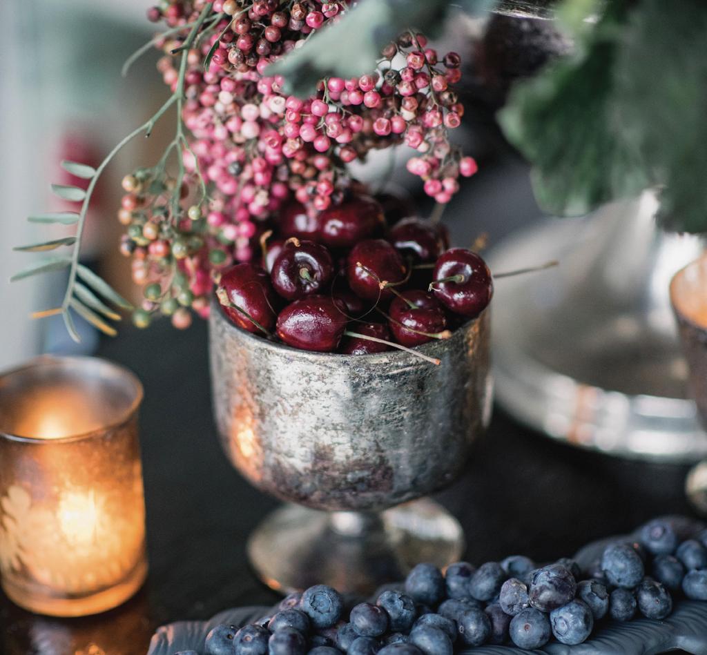 Clusters of rich-hued fruit—cherries, blueberries, blackberries, and pomegranates—offered organic opulence to reception tablescapes.