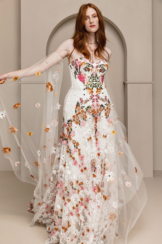 Rue de Seine “Cora” embroidered gown with cascading oral tulle train in “Meadow,” $3,950 at Lovely Bride.